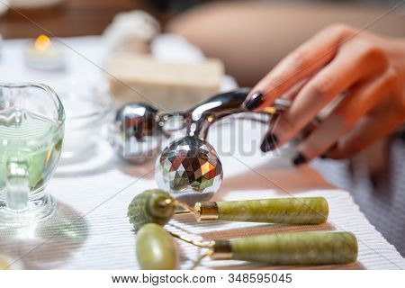 Lady Is Using Modern Massagers For Facebuilding
