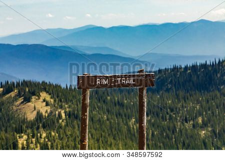 A Wooden Signboard On The Top Of The Mountain Hill. Rim Trail Sign In The Kootenay Valley Mountains,