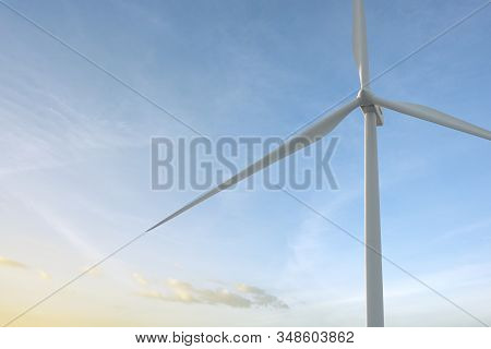 Close-up Wind Turbine In Rotation To Generate Electricity Energy On Outdoor With  Blue Sky Backgroun