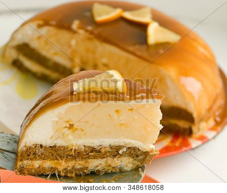 Cut Orange Caramel Mousse Cake With Cream Cheese Mascapone And Chocolate Glaze With Orange Pieces Cl