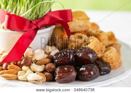 Nowruz Holiday Concept - Grass, Baklava Sweets, Nuts And Seeds, Copy Space