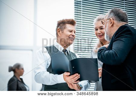 Close Up. Experienced Company Employees Discussing Business Documents