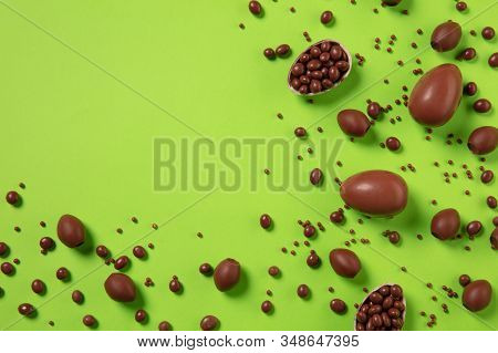 Egg Hunt Is Coming. Easter Traditions, Chocolate Eggs On Green Background, Top View, Copyspace For Y
