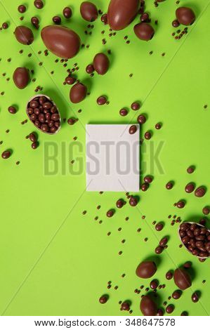 Egg Hunt Is Coming. Easter Traditions, Chocolate Eggs On Green Background, Top View, Copyspace For Y
