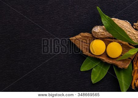 Cinnamon, Soth, Javitri And Herbal Medicines With Green Leaves On Black Background. Ayurvedic Concep