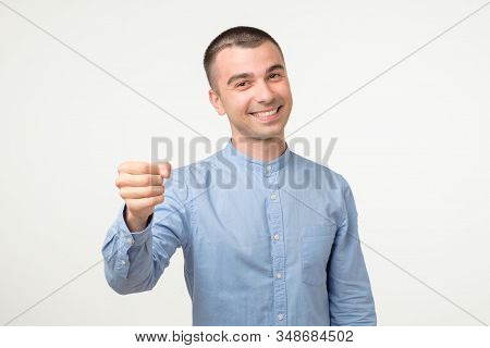 Gimme Geture. Young Hispanic Man Doing Fist Bump On White Studio Shoot