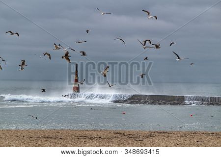 Breakwater And Lighthouse In A Cloudy Day Of Aguda Beach, Miramar, Arcozelos Town