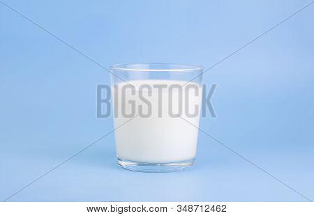 Fresh Farm Milk, Fermented Milk Product, In A Glass Cup, On A Holoumny Background. Selective Focus. 