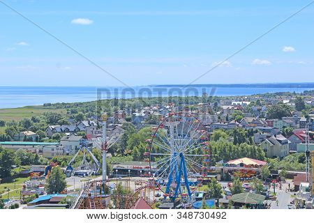 Wladyslawowo / Poland. 24 June 2019: 
Ferris Wheel On Blue Sky Background. Panorama Of Wladyslawowo 