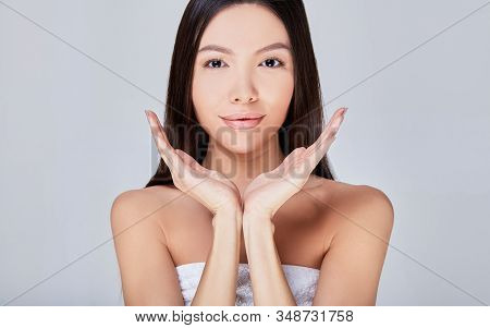 Attractive Asian Lady With Dark Hair Looking Staight At Frame On White Background. Cosmetology, Fres