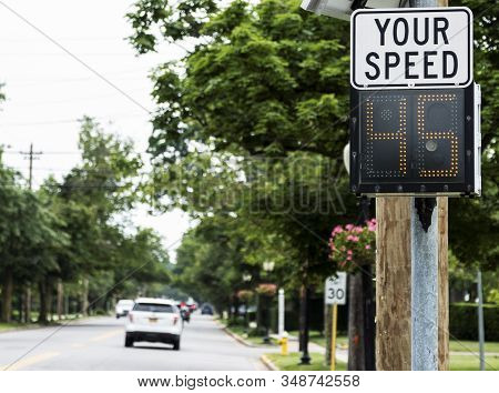 A Radar Gun Is Posting Your Driving Speed On A Sign As You Enter Babylon Village.