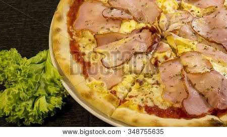 Karnos Pizza With Cheese, Sauce And Ham, Bacon, Smoked Chicken And Egg Is On The Table 2