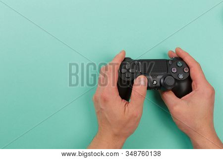 Russia, Oktober 24 2019: Male Hands Holding A Ps4 Controller, Sony Playstation 4 Game Console.