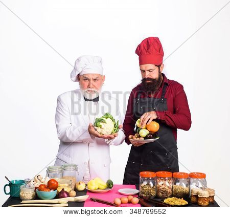 Chef. Two Chefs With Vegetable. Healthy Food. Professional Culinary. Bearded Man In Kitchen Apron. B