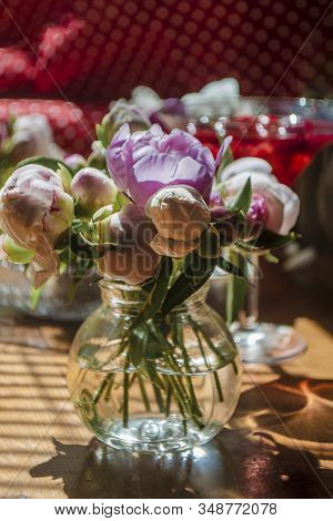 Beautiful Little Bouquet Of Undiscovered White Pink Peonies Against The Background Of A Red Drink In