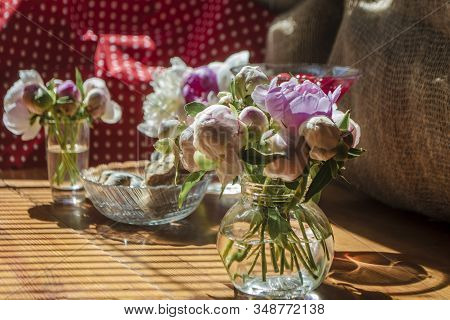 Beautiful Little Bouquet Of Undiscovered White Pink Peonies Against The Background Of A Red Drink In
