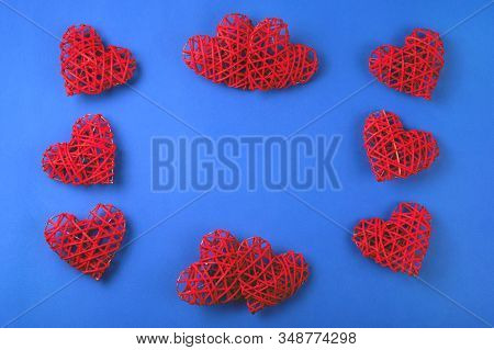 Beautiful Pattern Of The Red Wicker Hearts On The Cornflowerblue Background. St Valentines Concept W