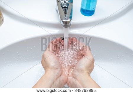 Woman Washing Hands Under The Faucet With Water, Hygiene And Profilactics Concept.