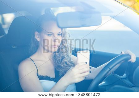 woman texting and talking on cellphone or mobile phone