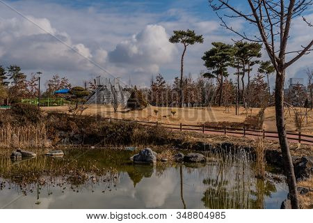 Landscape Of Pond And City Public Park On Beautiful Cloudy Winter Day.