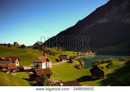 Lake Lungern Switzerland - Famous Fishing Lake In Switzerland. View Of Church And Lake
