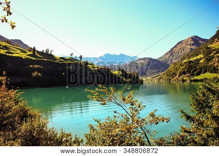 Lake Lungern Switzerland - Famous Fishing Lake In Switzerland. Trees And Reflection By Lake