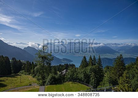 Swiss Alps Landscape Up In Rigi Kalrtbad, With Trees, Mountains And Blue Sky