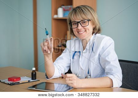 Doctor With Syringe In Hands Close Up.