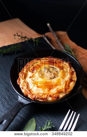 Food Concept Homemade Golden Meat Puff Pastry Pie In Skillet Iron Cast On Black Slate Board With Cop