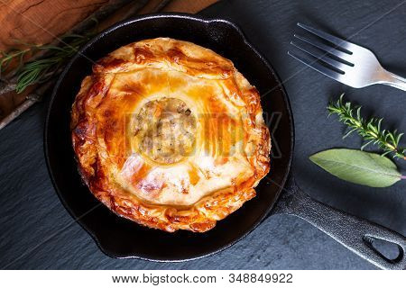 Food Concept Homemade Golden Meat Puff Pastry Pie In Skillet Iron Cast On Black Slate Board With Cop