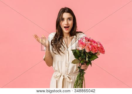 Surprised And Happy, Excited Pretty Young Woman Receive Flowers And Looking Astonished By Romantic N