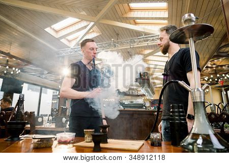 Two Masters Barmen Prepare Hookah Sisha In Hookah Bar. Tabaco Preparation.