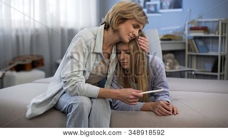 Mum Embracing Upset Daughter, Teenage Pregnancy, Holding Test, Support And Care