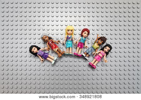 Kouvola, Finland - 18 December 2019: Lego Friends Minifigures Are Lying In An Arc On The Gray Basepl