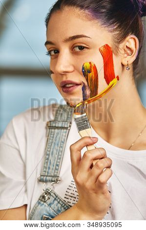 Beauty Art Concept, Portrait Of A Young Girl Painted With Different Colors Of Paint. Color Demos, Co