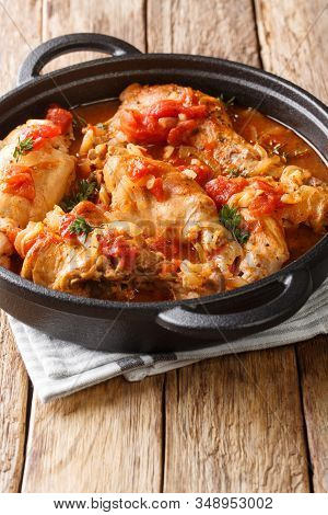 Braised Rabbit In Tomato Sauce With White Wine And Herbs Close-up In A Pan. Vertical