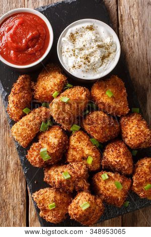 Coconut Crispy Chicken With Two Sauces Close-up On A Slate Board. Vertical Top View