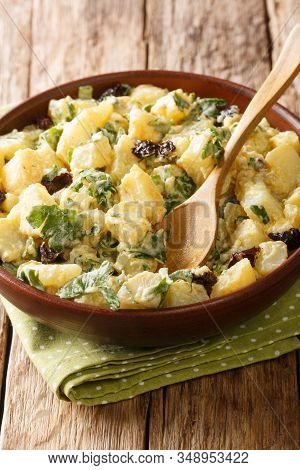 African Potato Salad With Yogurt, Herbs, Spices And Dried Olives Close-up In A Bowl. Vertical