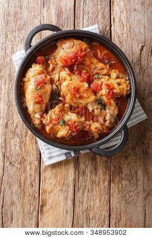 Braised Rabbit In Tomato Sauce With White Wine And Herbs Close-up In A Pan. Vertical Top View