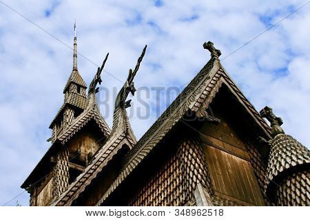 Fantoft Stave Medieval Wooden Church And Architecture, White Puffy Clouds In A Blue Summer Sky, Berg