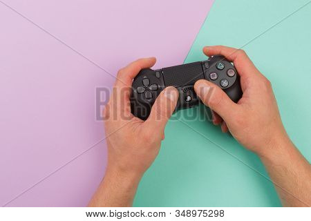 Russia, Oktober 24 2019: Male Hands Holding A Ps4 Controller, Sony Playstation 4 Game Console.