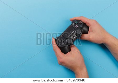 Russia, Oktober 24 2019: Male Hands Holding A Ps4 Controller, Sony Playstation 4 Game Console.