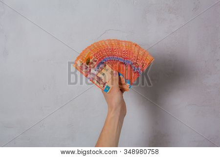 Hand Hold A Lot Of Money. Tenge Kzt. National Currency Of Kazakhstan, Kz. Exchange Rate. Economy, De