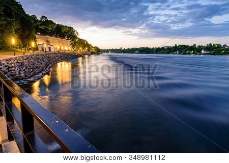 City Embankment In Narva. Narova River, Beautiful Night View, Estonia.