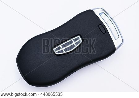 Minsk, Belarus - February 2022: Close-up Of A Black Smart Key From A Geely Tugella Car On A White Ba