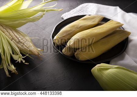 Tamales De Elote, Also Called Uchepos. Typical Mexican Dish. Can Be Served With Green Salsa And Acco