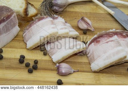 Ukrainian Products Raw Lard With Peppercorn And Garlic, Knife, Slices Of Bread, Salo Lying On Wooden
