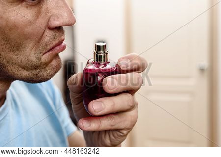 Young Ill Man Trying To Sense Smell Of Perfume