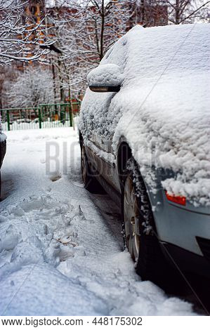 Fresh Snow On The Car. The First Snowfall And The End Of Autumn. Change Of Weather From Autumn To Wi