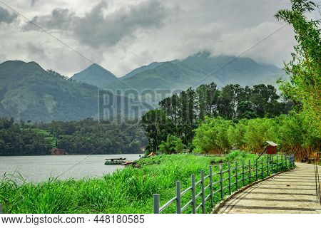 Lake Serene With Beautiful Hiking Trails And Mountain Background Image Is Taken At Banasura Sagar Da